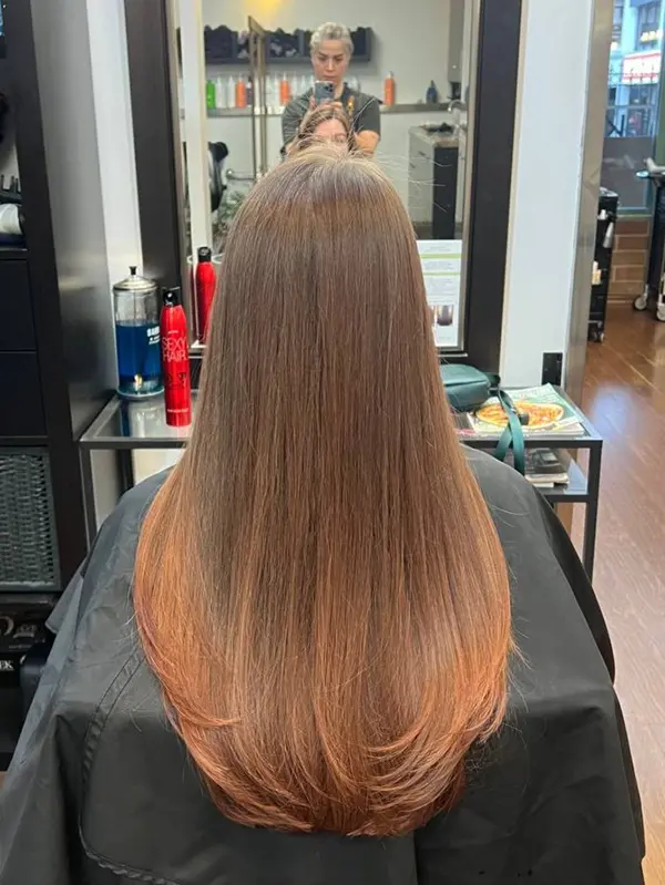 Long brunette hair with a soft caramel balayage and a smooth, glossy finish by CocoRez in Port Coquitlam.