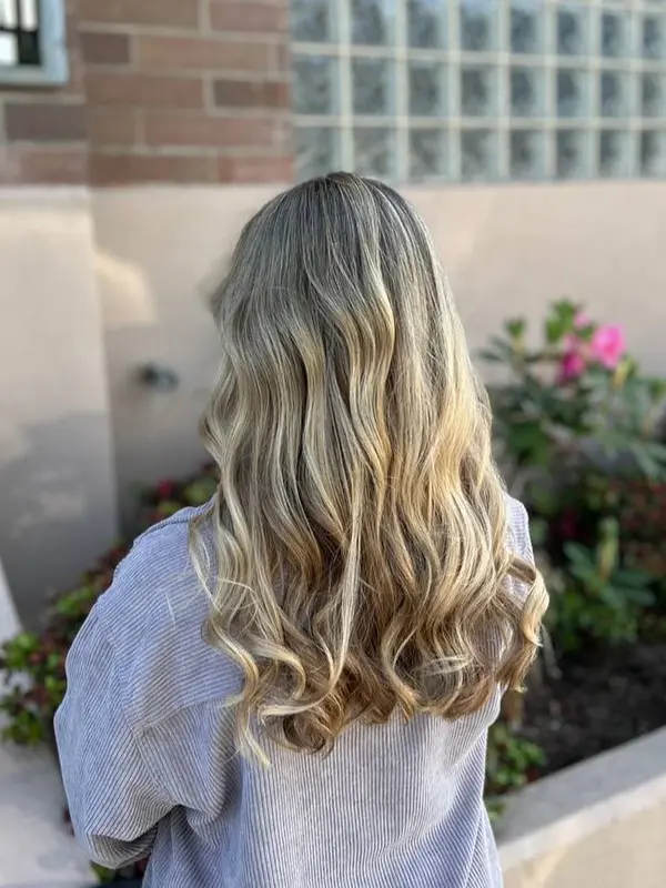 Soft blonde balayage with seamless colour blending and loose waves by CocoRez in Port Coquitlam.