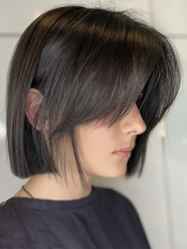 Face-framing bangs cut with a sleek bob hairstyle by CocoRez in Port Coquitlam.