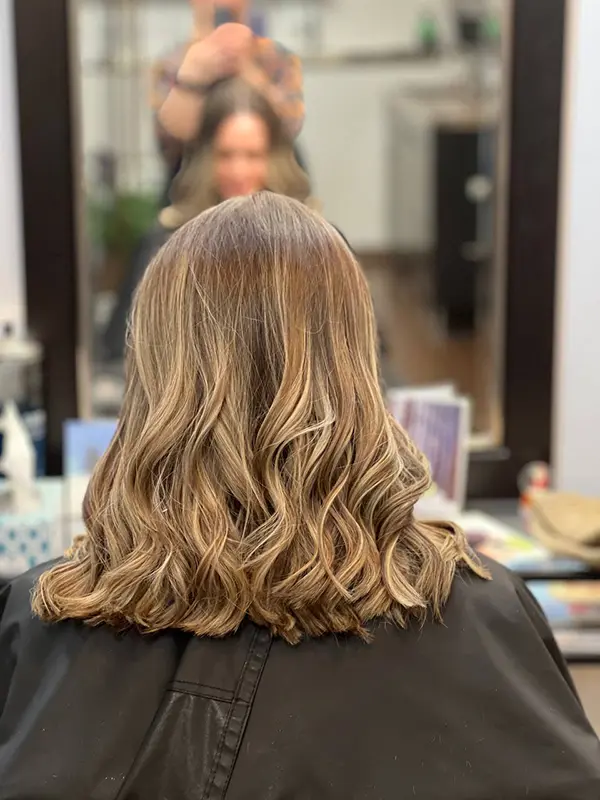 Beige blonde highlights blended into medium-length hair by CocoRez in Port Coquitlam.