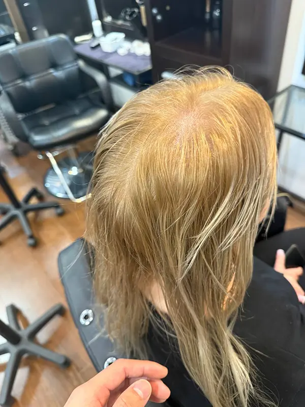 Before professional hair bleaching, showing warm blonde hair prior to lightening at CocoRez in Port Coquitlam.