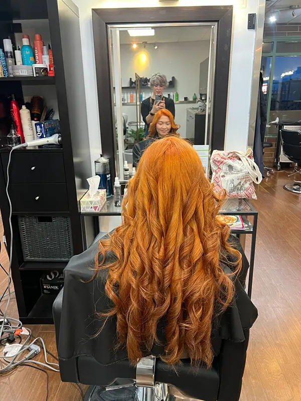 Copper hair color with soft curls by CocoRez in Port Coquitlam.