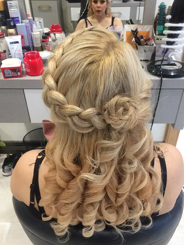 Blonde half-up hairstyle with a soft crown braid and loose curls by CocoRez in Port Coquitlam.