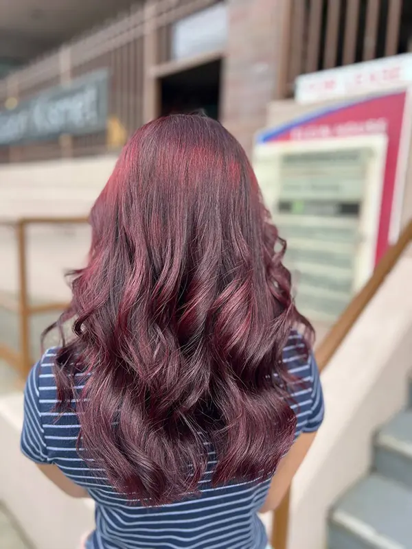 Rich burgundy hair color with soft waves by CocoRez in Port Coquitlam.