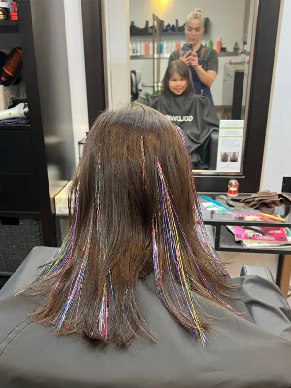 Colourful hair tinsel professionally installed on natural hair at CocoRez in Port Coquitlam.