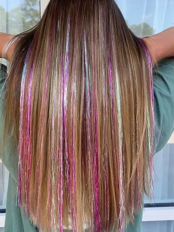 Pink and silver hair tinsel professionally installed on long blonde hair at CocoRez in Port Coquitlam.