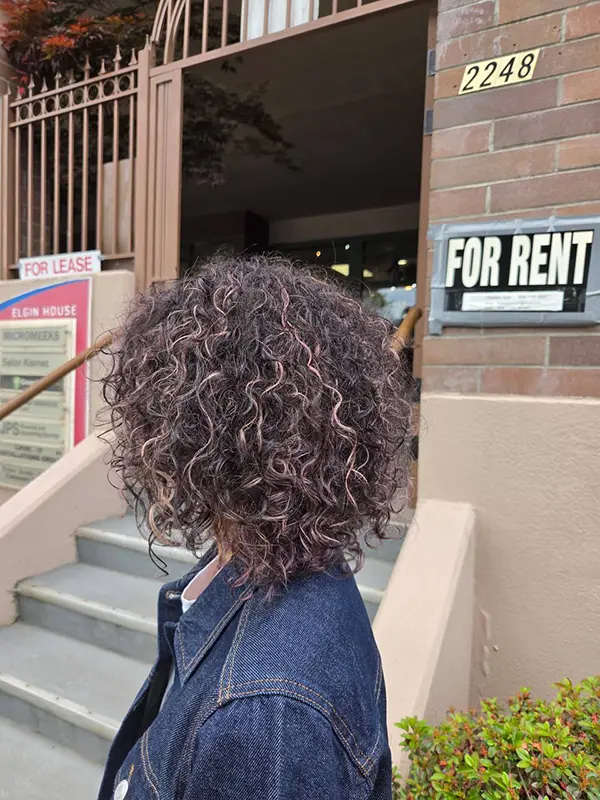 Curly hair refreshed with a cool-toned hair toner for enhanced shine and balanced colour by CocoRez in Port Coquitlam.