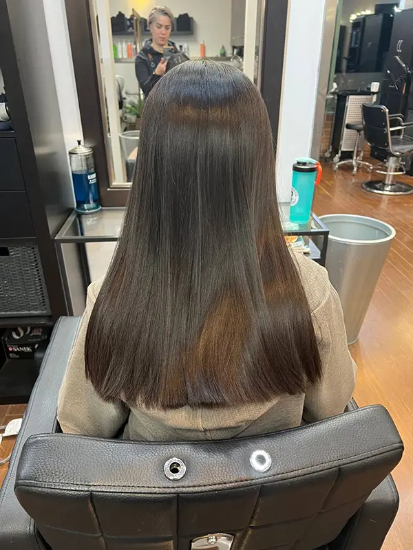 Long dark hair with a smooth, glossy finish after a professional hair treatment by CocoRez in Port Coquitlam.