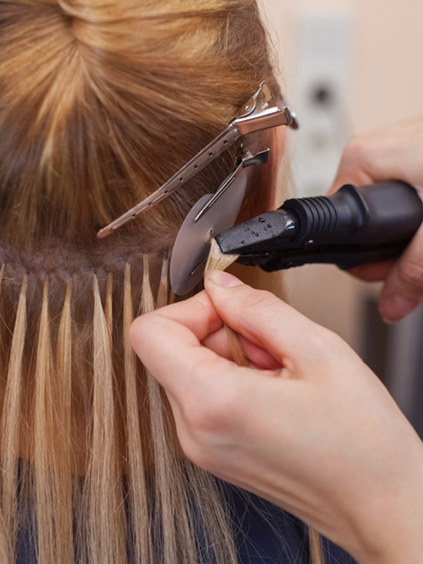 Professional keratin hair extension installation in progress at CocoRez in Port Coquitlam.