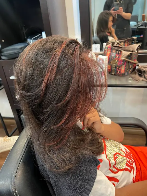 Long face-framing bangs with layered hair by CocoRez in Port Coquitlam.