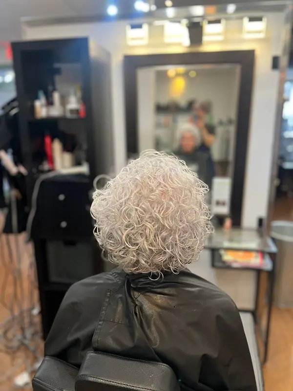 Naturally curly hair styled after a professional shampoo and blow-dry service by CocoRez in Port Coquitlam.