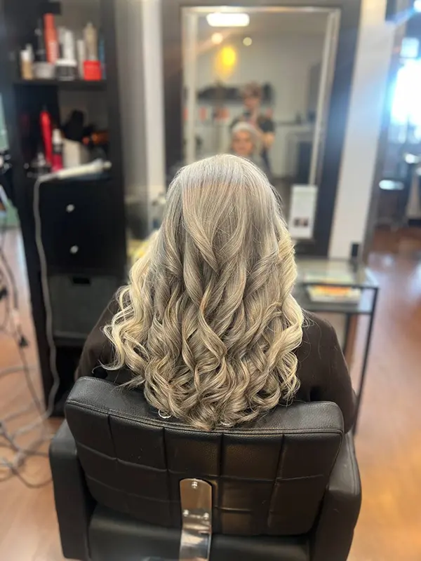 Silver hair styled with soft curls after a professional shampoo and blow-dry service by CocoRez in Port Coquitlam.