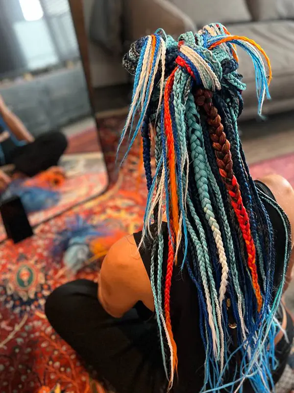 Colourful festival braided hairstyle with vibrant synthetic hair extensions created by CocoRez in Port Coquitlam.