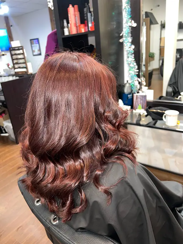 Warm auburn hair color with a glossy finish and soft curls by CocoRez in Port Coquitlam.
