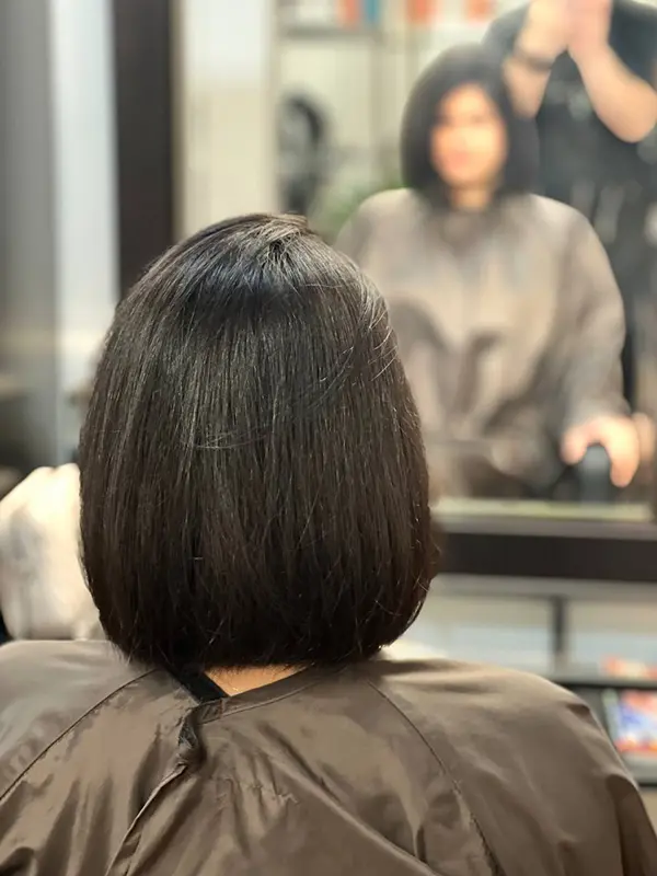 After a women's classic bob haircut with a sleek finish by CocoRez in Port Coquitlam.