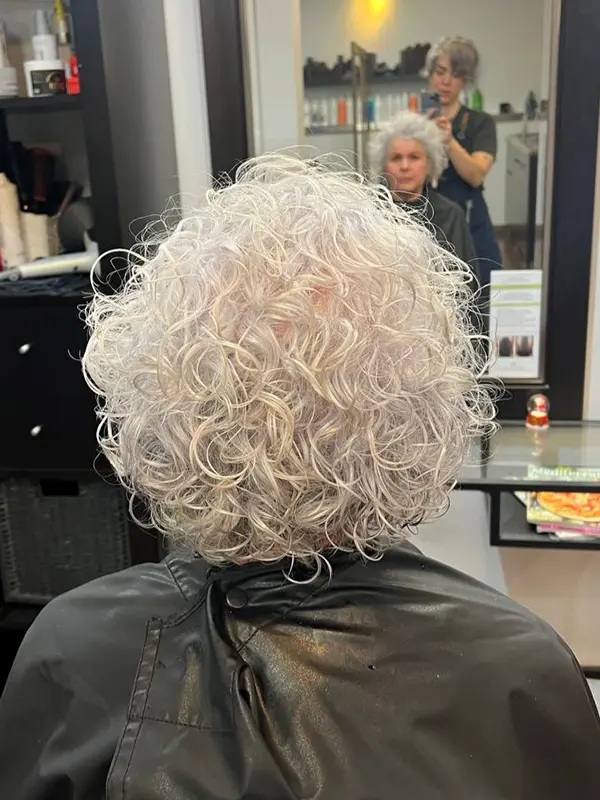 Women's short curly haircut with soft natural shape by CocoRez in Port Coquitlam.