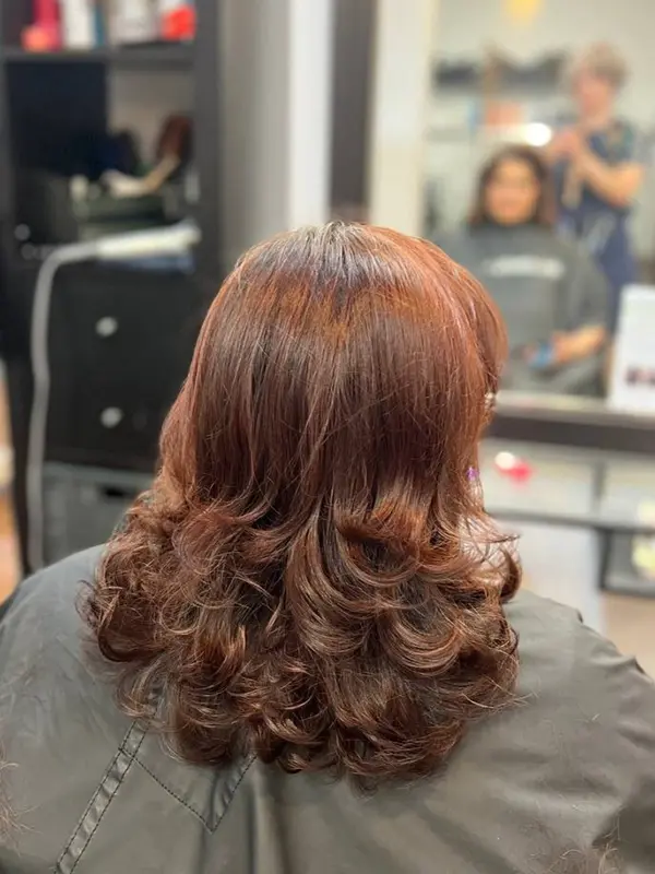 Women's layered haircut with soft curled ends styled at CocoRez in Port Coquitlam.