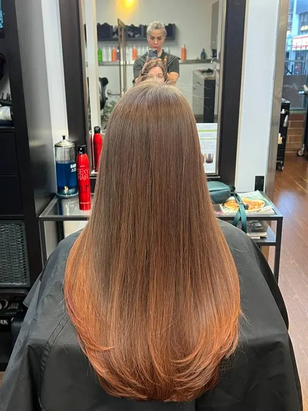 Women's long layered haircut with a smooth sleek finish by CocoRez in Port Coquitlam.