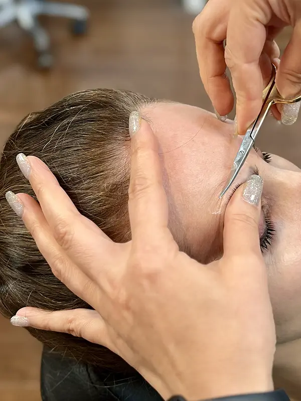 Professional eyebrow trimming during an eyebrow threading service at CocoRez in Port Coquitlam.