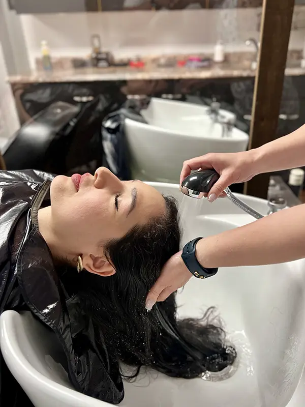 Client enjoying a relaxing head spa scalp rinse at CocoRez in Port Coquitlam.